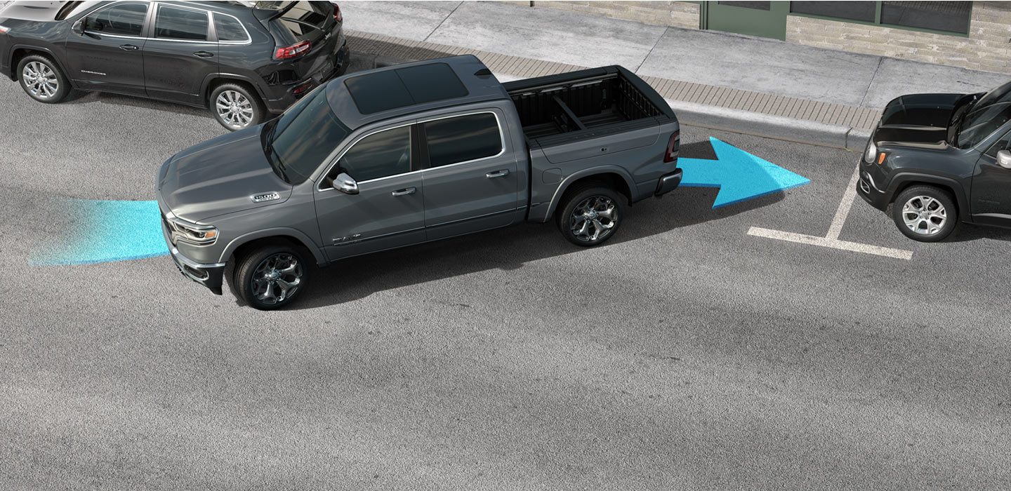 A 2020 Ram 1500 backing into a parking spot with a blue arrow illustrating how the vehicle assists the driver when parking.
