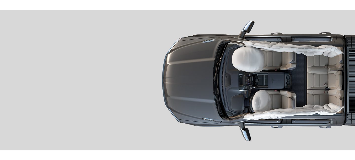 An overhead view of the interior of the 2020 Ram 1500 illustrating fully deployed front and side-curtain airbags.