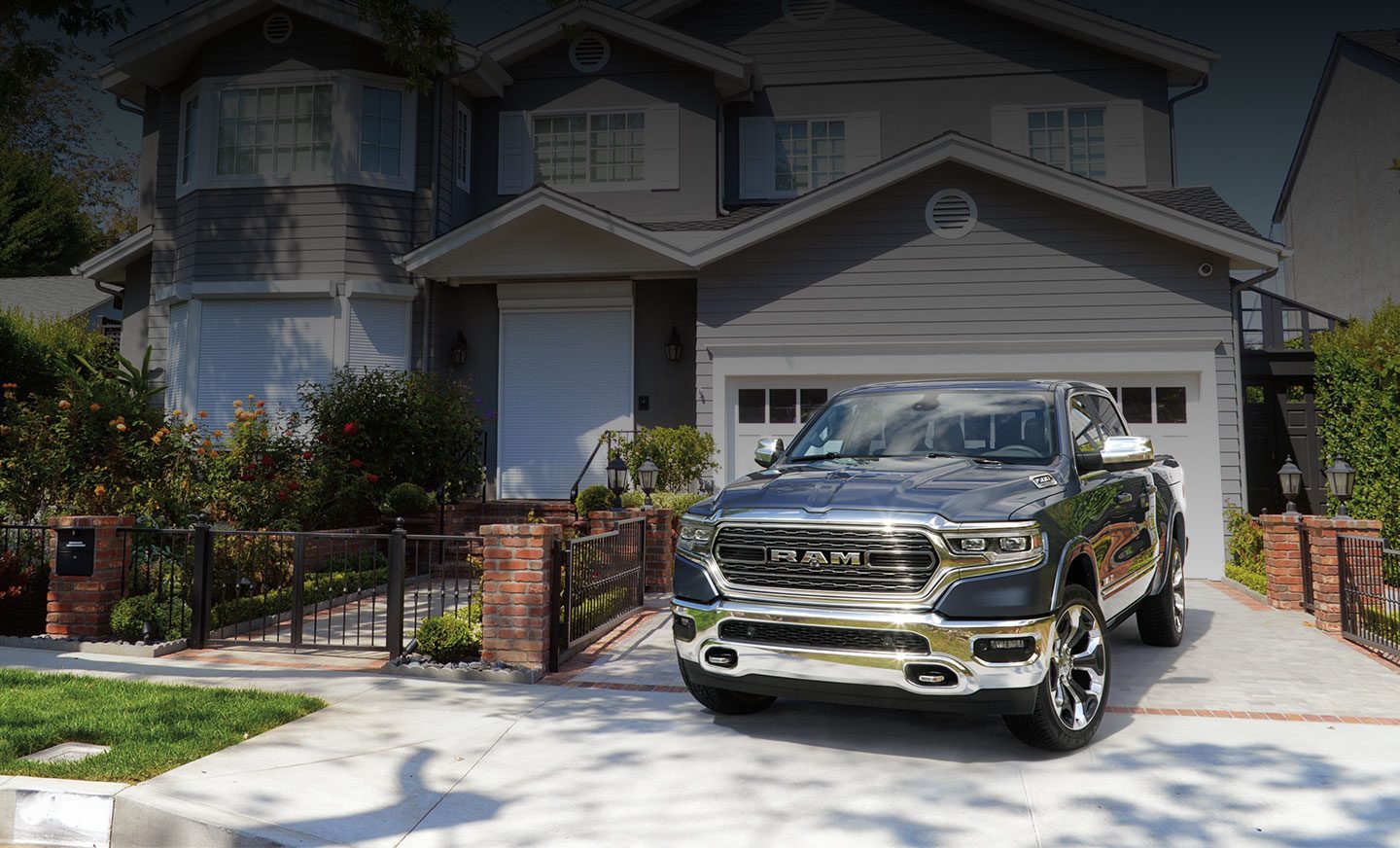 The 2020 Ram 1500 parked in the driveway of a neighborhood home.