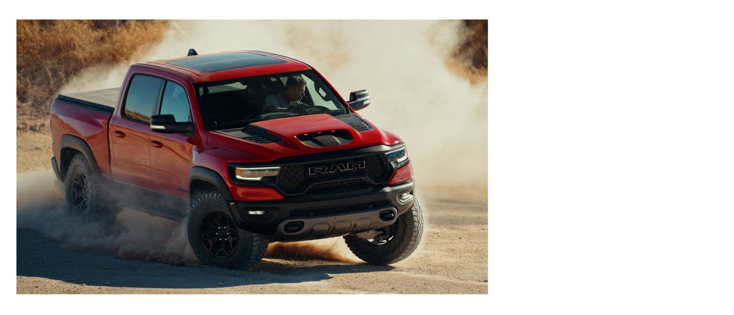 The 2022 Ram TRX being driven off-road on sand.