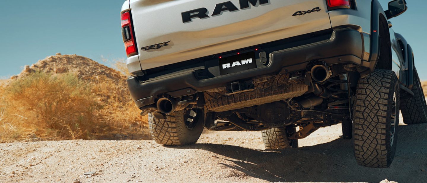 The 2022 Ram TRX being driven on uneven, rocky ground.