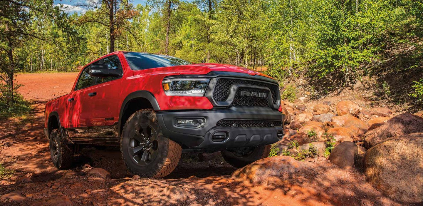 Display The 2023 Ram 1500 being driven off-road on a red rock trail.