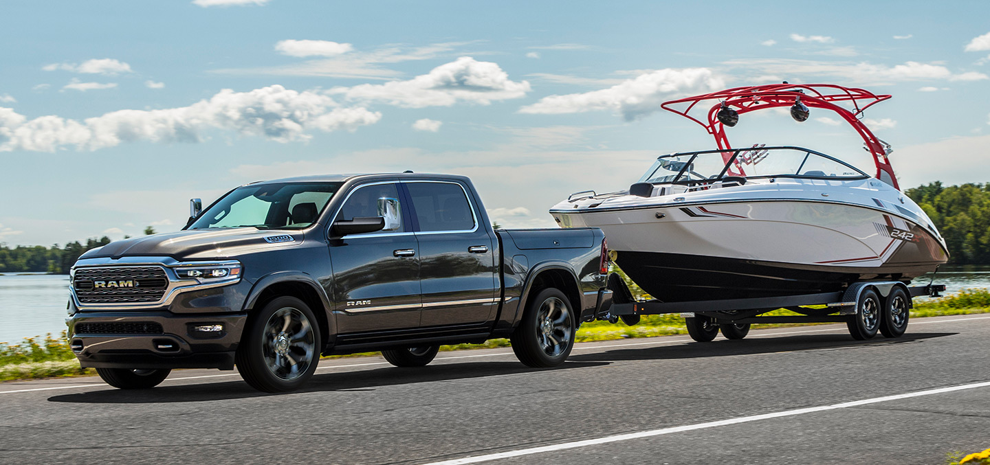 The 2023 Ram 1500 towing a motorboat.
