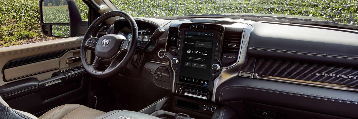 The interior of the 2023 Ram Chassis Cab, focusing on the steering wheel, touchscreen, center stack controls and dash.