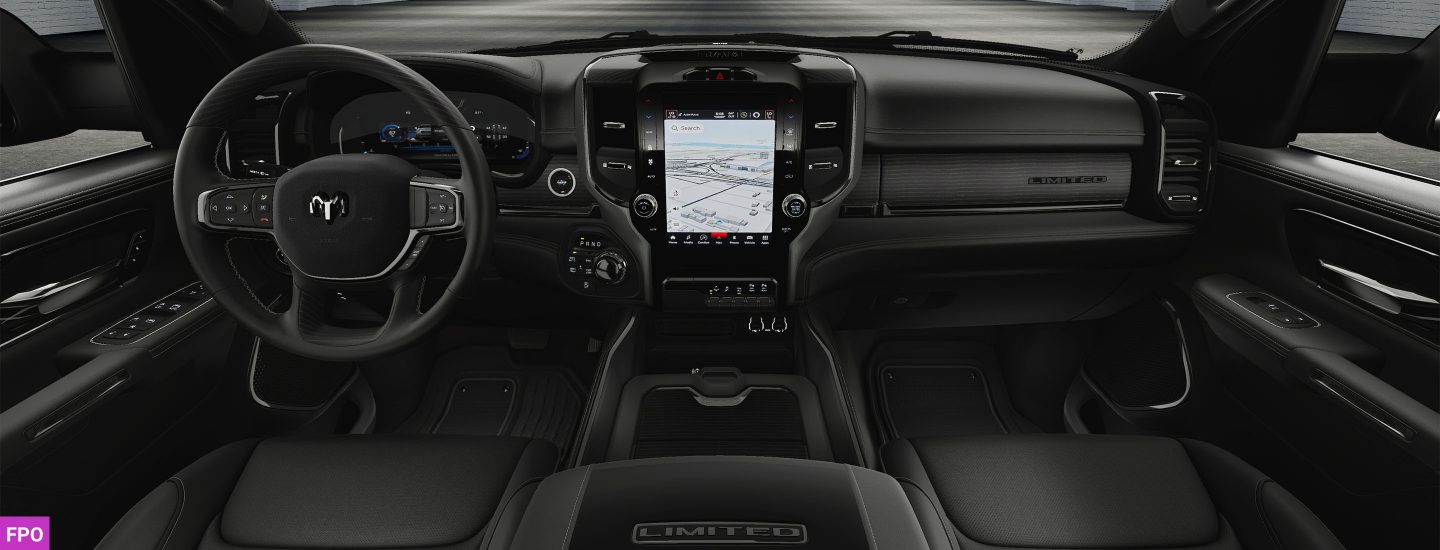 The steering wheel and large touchscreen in the 2023 Ram 2500 Limited Night Edition.