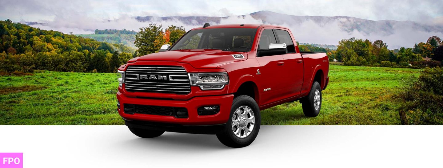 A front angle of a red 2023 Ram 2500 Laramie Crew Cab with the Sport Appearance Package.