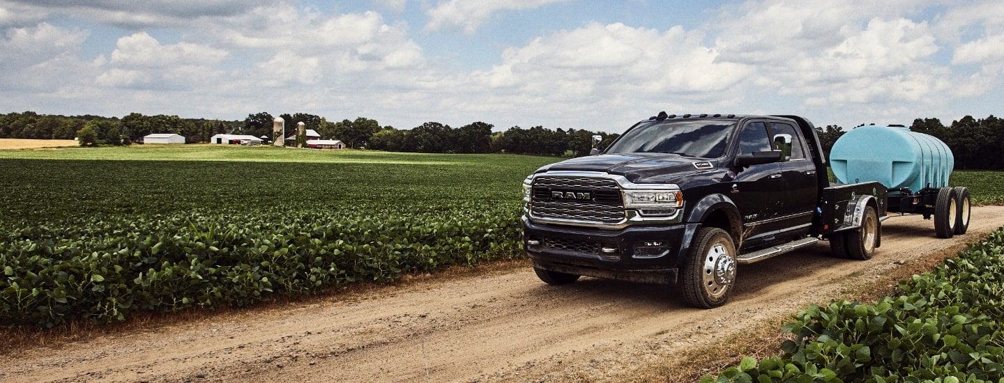A Ram 2500 towing a trailer with a tank on it.