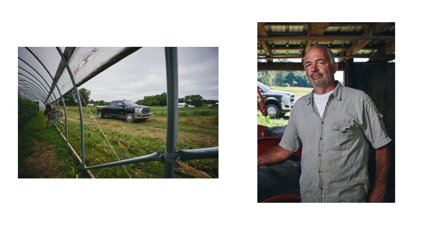 The view through a greenhouse window of a Ram 2500 in a field. A farmer with his arm braced on a tractor wheel.